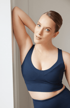Model wearing the Le Divine bra in navy blue, made from OEKO-TEX® certified compression fabric with Elastique’s MicroPerle® technology to enhance circulation, promote lymphatic drainage, and relieve pain.