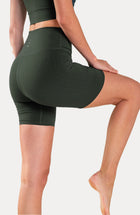 Model wearing the L’Original Bike Short in Olive, made from OEKO-TEX® certified compression fabric featuring Elastique’s MicroPerle® technology to promote lymphatic drainage, enhance circulation, reduce fatigue, and smooth the skin.