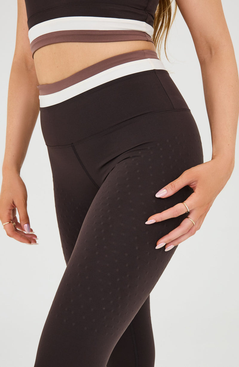 Le Monde leggings and bra in Java, Ivory, and Cappuccino colors made from OEKO-TEX® certified compression fabric featuring Elastique’s MicroPerle® technology to promote lymphatic drainage, improve circulation, reduce fatigue, and smooth the skin.