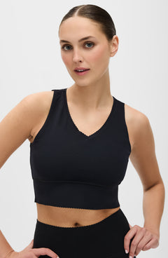Adorn bra in black featuring an elegant scallop trim, crafted from OEKO-TEX® certified compression fabric with Elastique’s MicroPerle® technology to promote lymphatic drainage, improve circulation, and reduce fatigue.