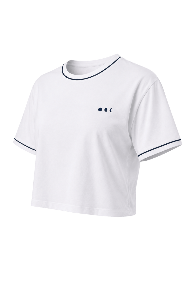 White cropped tee with navy trim from the Monte Carlo collection, featuring elegant resort-inspired activewear styling and versatile comfort for elevated everyday and poolside wear.