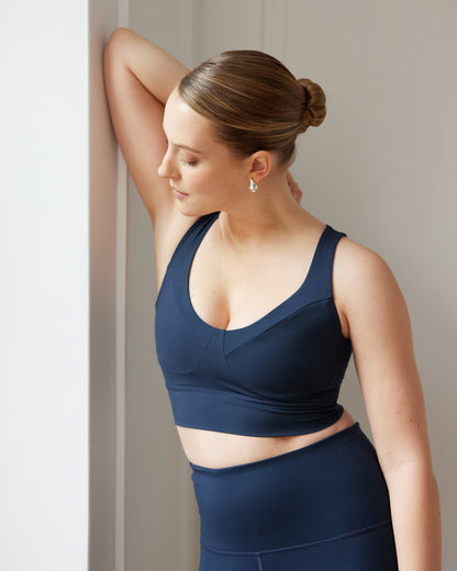Model wearing Le Divine bra in navy with MicroPerle on an oeko-tex compression fabric for better circulation, lymphatic drainage, pain relief