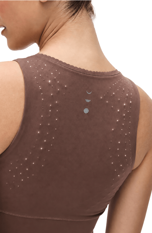 Rear view of a woman wearing a brown sleeveless top with micro pearl beads, shown against a white background.