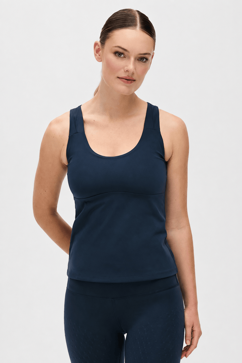 Model wearing the L’Original leggings and tank in navy blue, made from OEKO-TEX® certified compression fabric featuring MicroPerle® technology along the back to promote lymphatic drainage, improve circulation, and reduce fatigue.