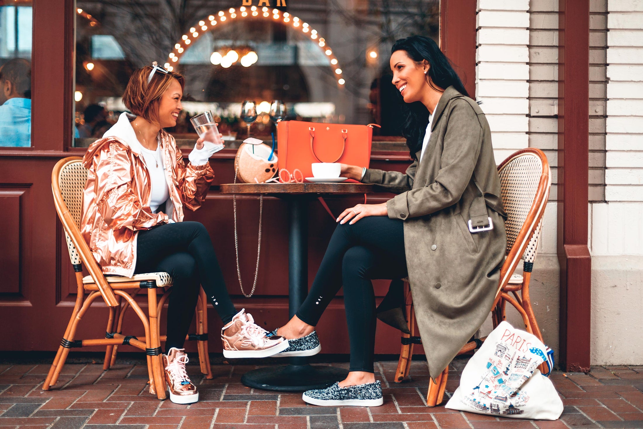 Models seated at a cafe talking