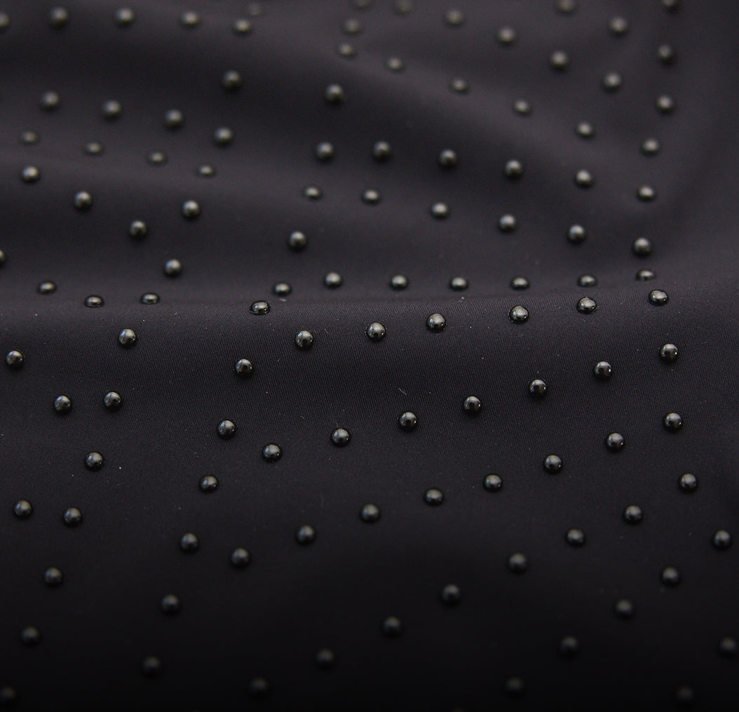 Black fabric with microperles in a pattern