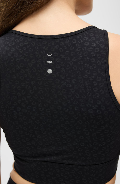 Load image 1 in gallery view. Model wearing the Fierce bra in cheetah print from Elastique’s Fierce collection, made from OEKO-TEX® certified compression fabric featuring MicroPerle® technology to enhance circulation, promote lymphatic drainage, and smooth the skin.