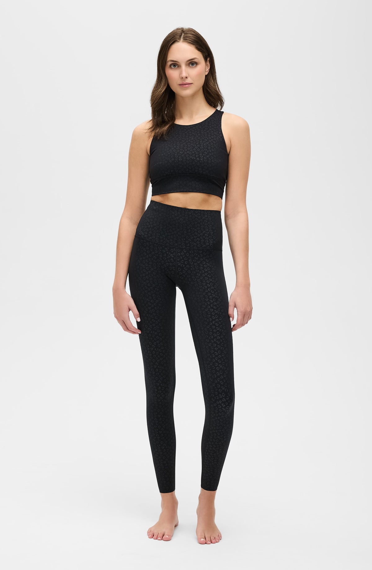 Model wearing The Fierce compression leggings and bra in black cheetah print