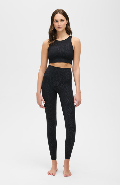 Load image 1 in gallery view. Model wearing The Fierce leggings and bra in black with cheetah print, made from OEKO-TEX® certified compression fabric featuring Elastique’s MicroPerle® technology to enhance lymphatic drainage, improve circulation, reduce fatigue, and smooth the skin.