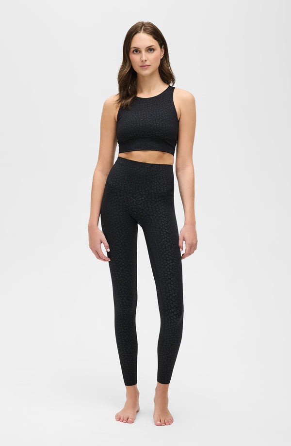 Model wearing The Fierce compression leggings and bra in black cheetah print