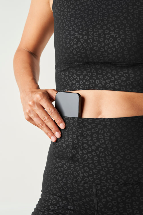 Load image 1 in gallery view. Model wearing The Fierce leggings and bra in black with cheetah print, made from OEKO-TEX® certified compression fabric featuring Elastique’s MicroPerle® technology to enhance lymphatic drainage, improve circulation, reduce fatigue, and smooth the skin.