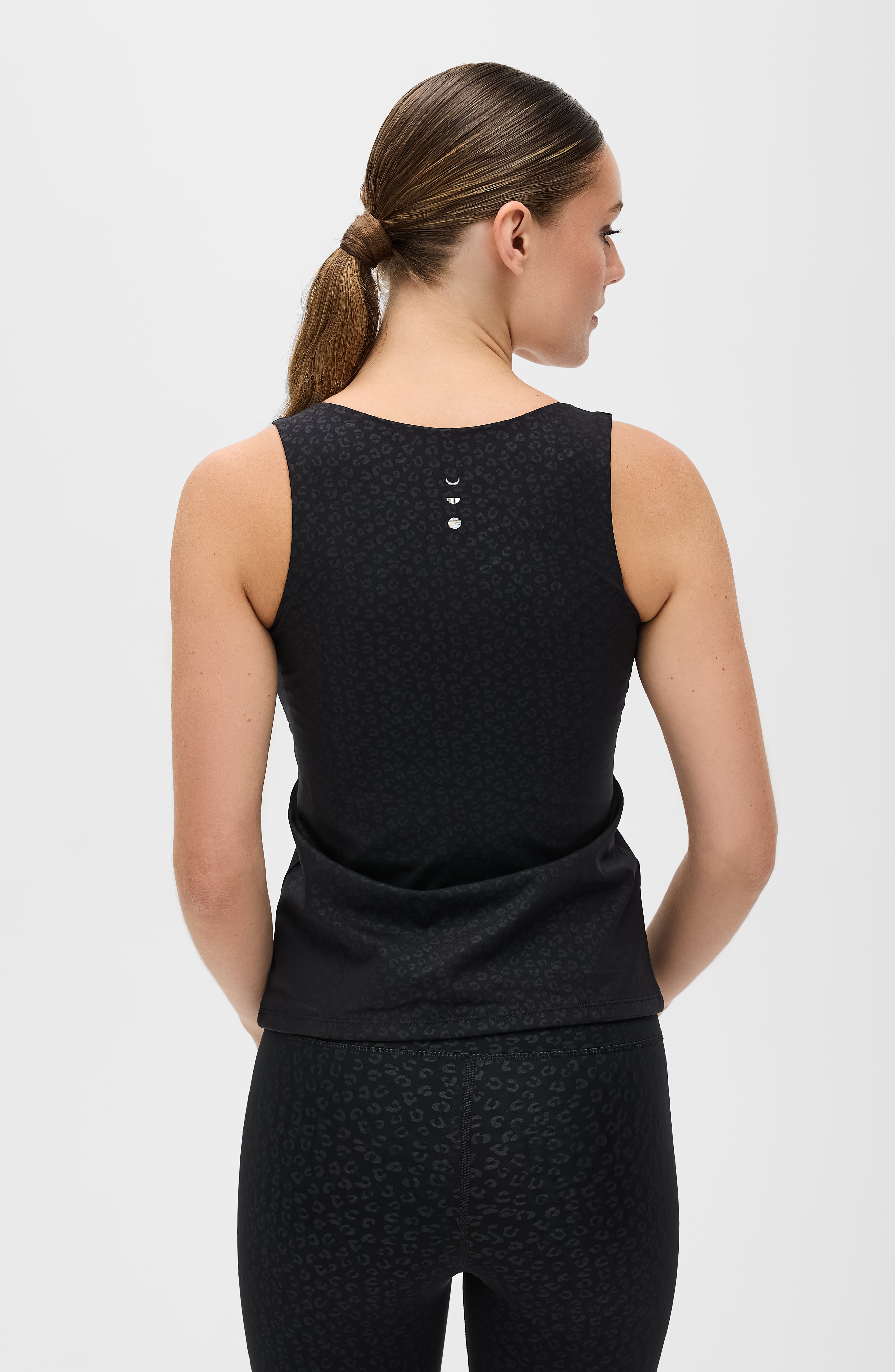 Fierce tank in cheetah print from Elastique’s Fierce collection, made from OEKO-TEX® certified compression fabric with MicroPerle® technology to enhance circulation, support lymphatic drainage, and smooth the skin.