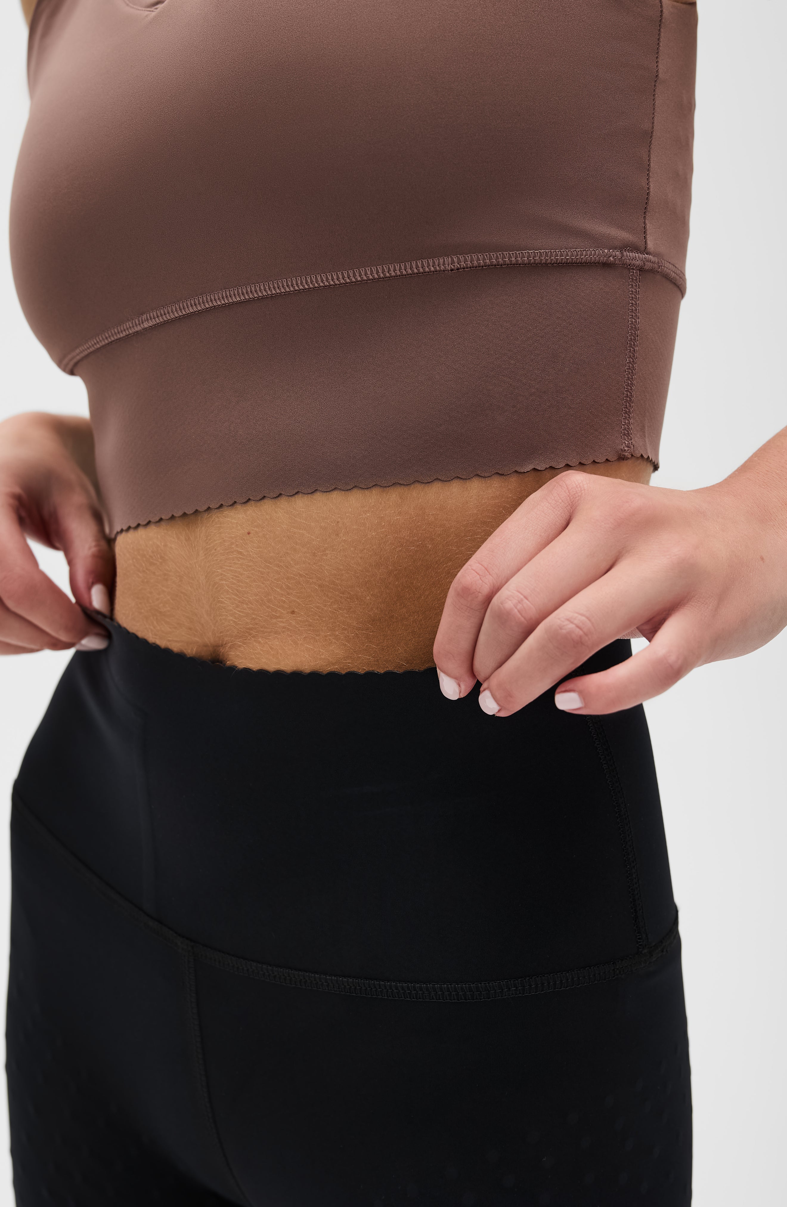 Adorn leggings in black & Adorn bra in cappuccino featuring an elegant scallop trim, made from OEKO-TEX® certified compression fabric with Elastique’s MicroPerle® technology to promote lymphatic drainage, boost circulation, reduce fatigue, and smooth the skin.