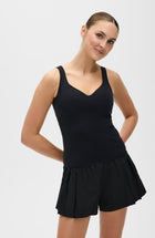 Iconic MicroPerle® tank in black, made from OEKO-TEX® certified compression fabric featuring Elastique’s patented MicroPerle® technology to enhance circulation, promote lymphatic drainage, and smooth the skin for an elevated performance fit.