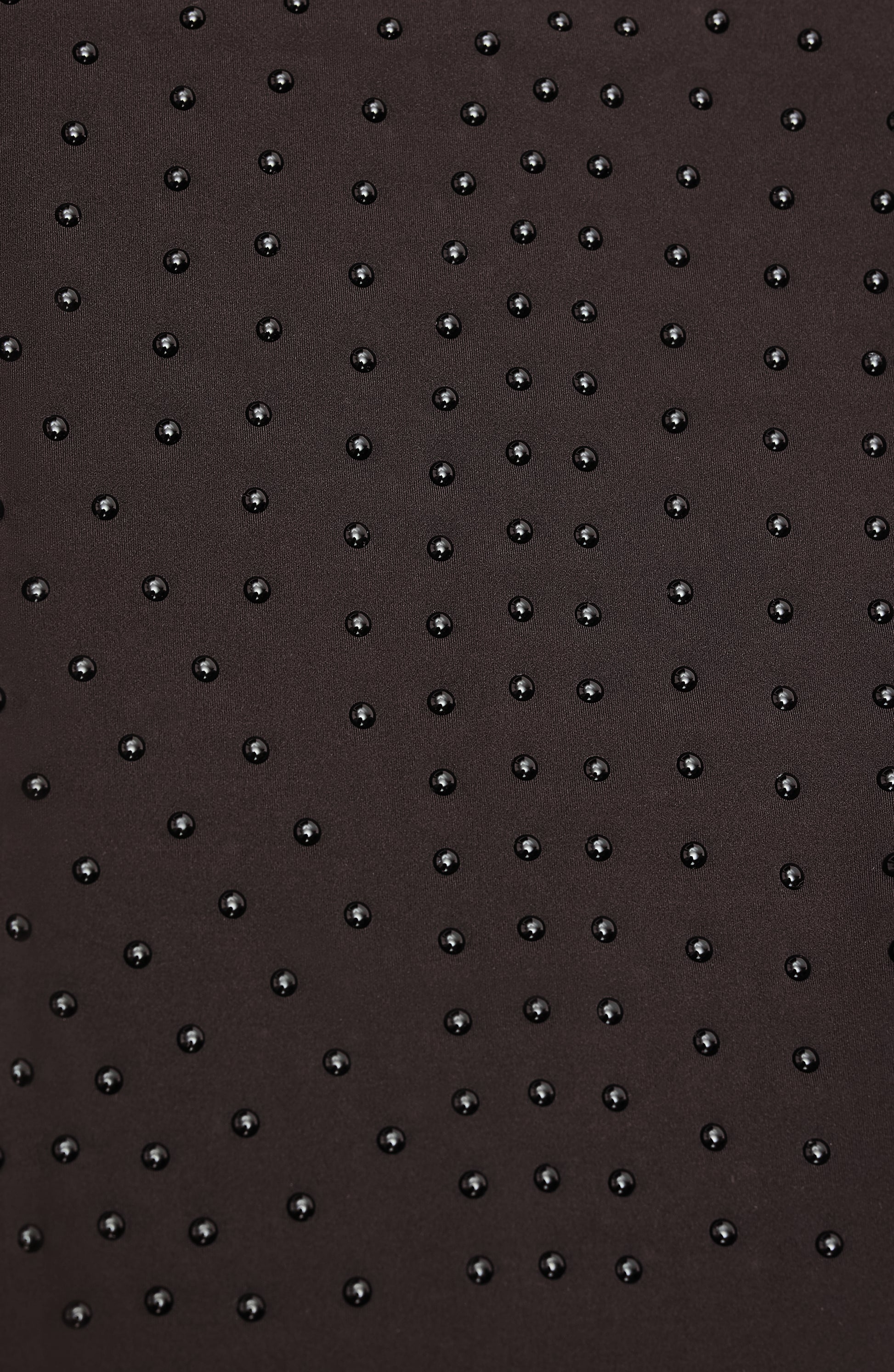 Close-up of Elastique’s MicroPerle® technology in java brown compression fabric, showing the textured microbeads designed to stimulate lymphatic drainage, improve circulation, and smooth the skin.