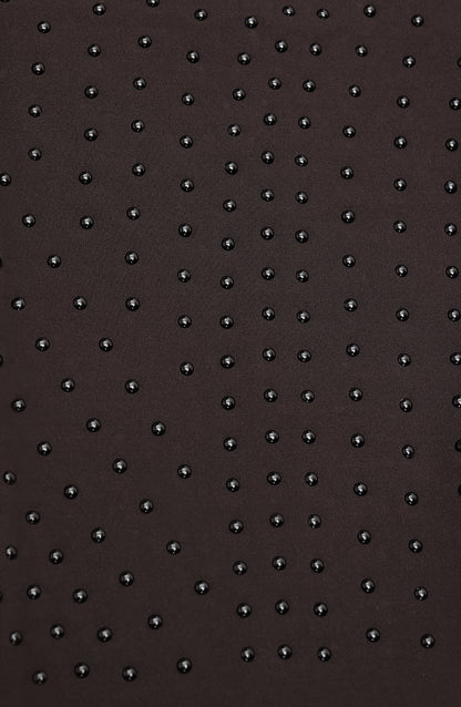 Close-up of Elastique’s MicroPerle® technology in java brown compression fabric, showing the textured microbeads designed to stimulate lymphatic drainage, improve circulation, and smooth the skin.