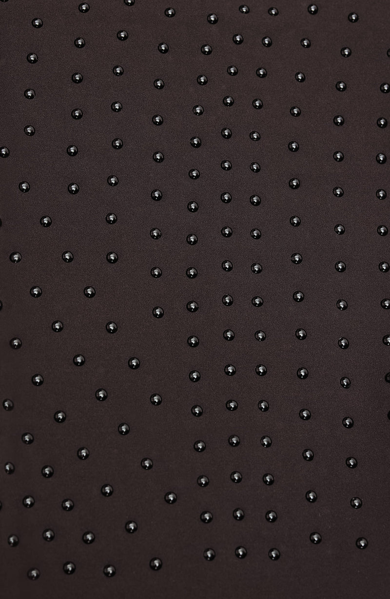 Close-up of Elastique’s MicroPerle® technology in java brown compression fabric, showing the textured microbeads designed to stimulate lymphatic drainage, improve circulation, and smooth the skin.