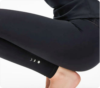 Model wearing the Lisse leggings with matching bra in black, crafted from OEKO-TEX® certified compression fabric designed to sculpt the silhouette, enhance circulation, and deliver a smooth, second-skin feel.