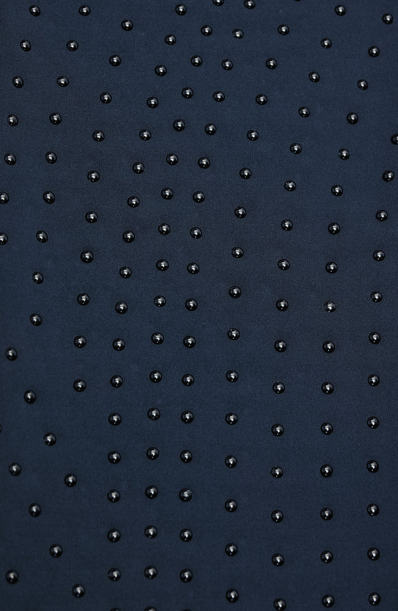 Close-up of Elastique’s MicroPerle® technology in navy blue compression fabric, showing the textured microbeads designed to stimulate lymphatic drainage, improve circulation, and smooth the skin.