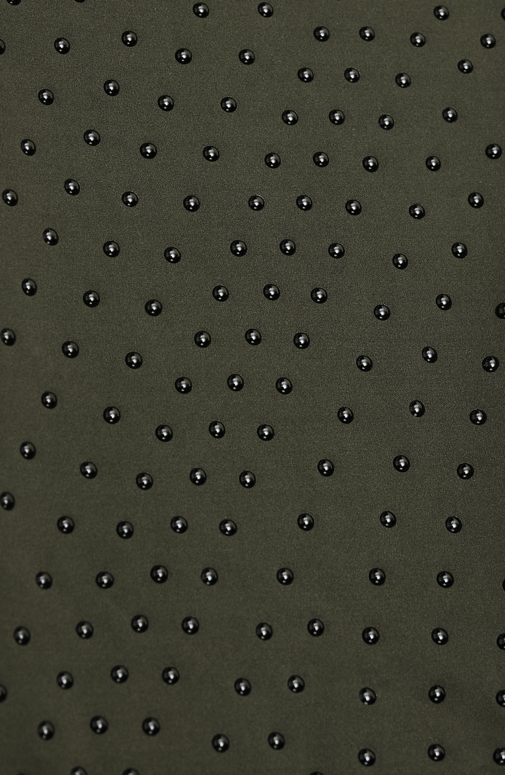 Close-up of Elastique’s MicroPerle® technology in olive green compression fabric, showing the textured microbeads designed to stimulate lymphatic drainage, improve circulation, and smooth the skin.