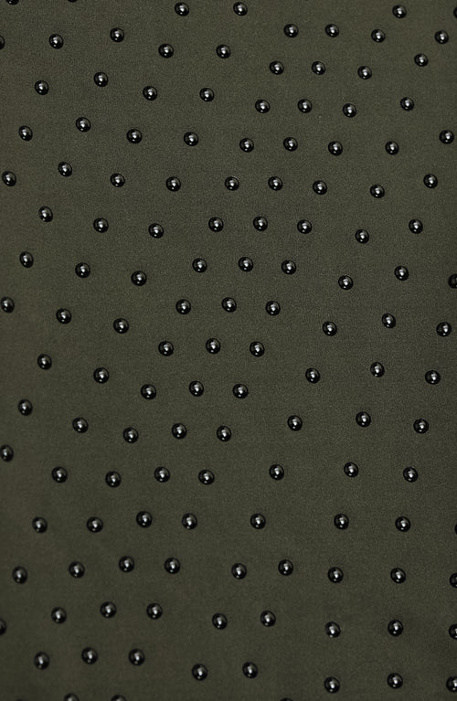 Load image 1 in gallery view. Close-up of Elastique’s MicroPerle® technology in olive green compression fabric, showing the textured microbeads designed to stimulate lymphatic drainage, improve circulation, and smooth the skin.