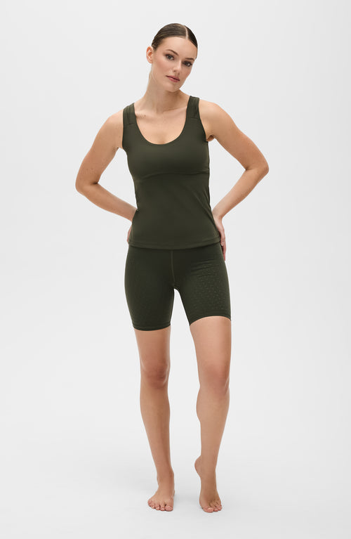 Load image 1 in gallery view. Model wearing the L’Original Bike Short with matching tank in Olive green, made from OEKO-TEX® certified compression fabric featuring Elastique’s MicroPerle® technology to promote lymphatic drainage, enhance circulation, reduce fatigue, and smooth the skin.