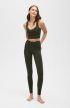 Model wearing the Le Divine bra in olive green, made from OEKO-TEX® certified compression fabric with Elastique’s MicroPerle® technology to enhance circulation, promote lymphatic drainage, and relieve pain.