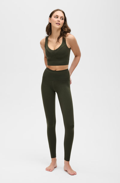 Model wearing the Le Divine bra in olive green, made from OEKO-TEX® certified compression fabric with Elastique’s MicroPerle® technology to enhance circulation, promote lymphatic drainage, and relieve pain.