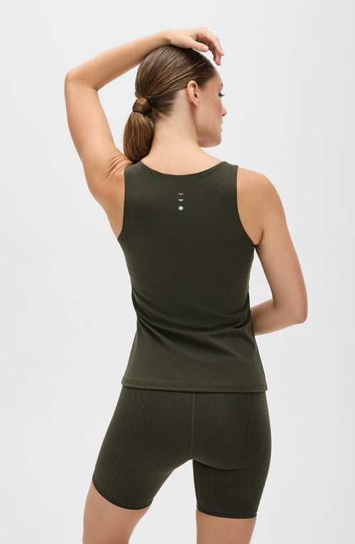 Load image 1 in gallery view. Model wearing the L’Original tank in olive green, made from OEKO-TEX® certified compression fabric featuring MicroPerle® technology along the back to promote lymphatic drainage, improve circulation, and reduce fatigue.