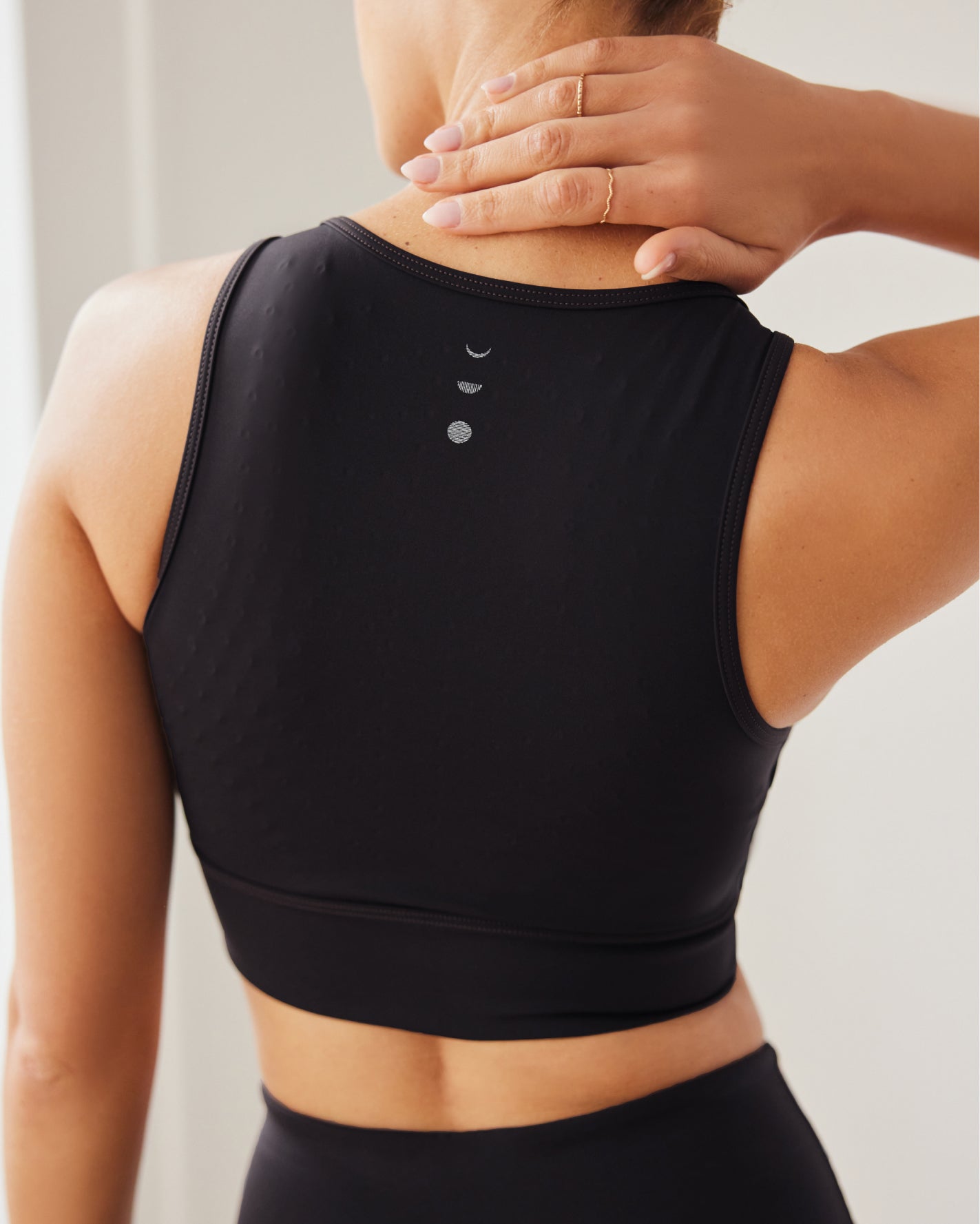 Model wearing Le Divine bra in black with MicroPerle on an oeko-tex compression fabric for better circulation, lymphatic drainage, pain relief